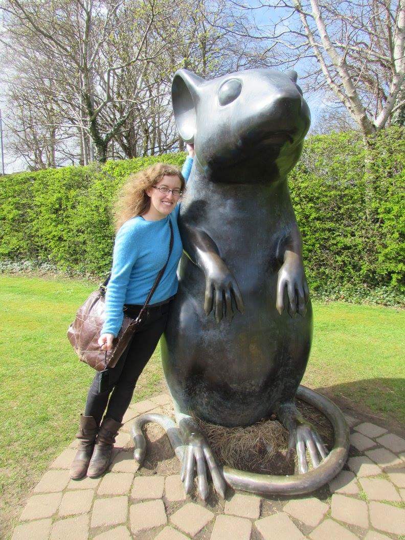 Karin with the mouse statue on the path at the Burns Museum